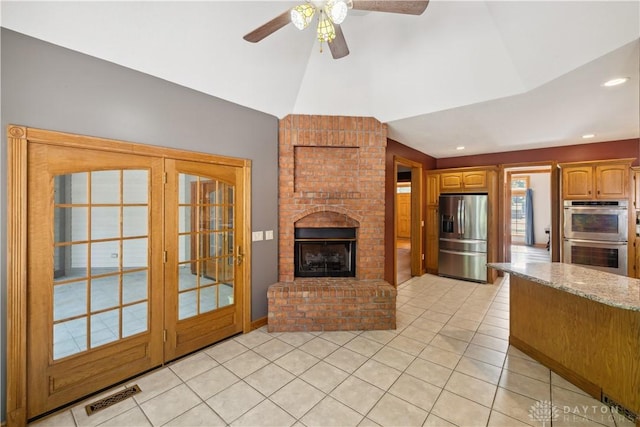 4384 New Market Banta Rd, Lewisburg, OH 45338 - kitchen featuring stainless steel appliances, light tile patterned flooring, light stone countertops, a ceiling fan, and high vaulted ceiling