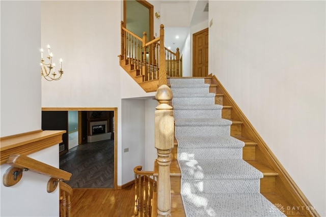 4384 New Market Banta Rd, Lewisburg, OH 45338 - staircase with a chandelier, a high ceiling, and baseboards