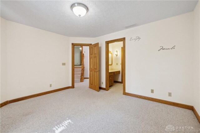 4384 New Market Banta Rd, Lewisburg, OH 45338 - unfurnished room featuring light carpet, baseboards, and a textured ceiling