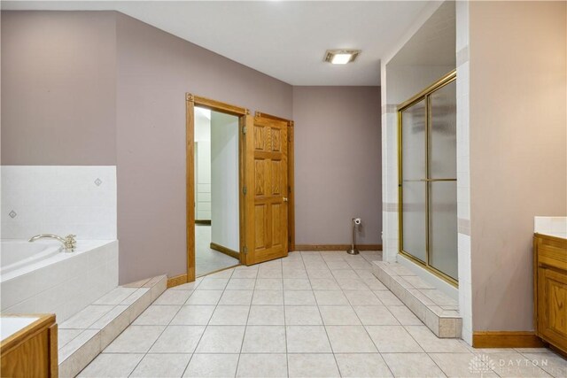 4384 New Market Banta Rd, Lewisburg, OH 45338 - full bath with a garden tub, vanity, a shower stall, and baseboards