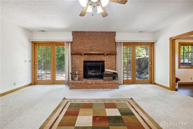 4384 New Market Banta Rd, Lewisburg, OH 45338 - unfurnished living room with carpet, a textured ceiling, a brick fireplace, baseboards, and ceiling fan