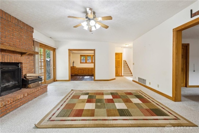 4384 New Market Banta Rd, Lewisburg, OH 45338 - unfurnished living room with carpet, stairway, a brick fireplace, a ceiling fan, and baseboards