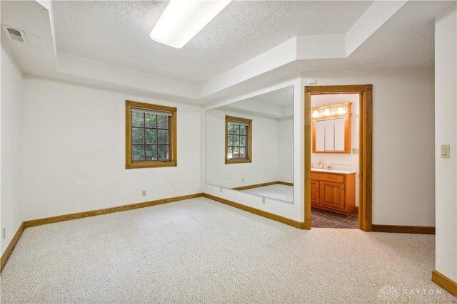 4384 New Market Banta Rd, Lewisburg, OH 45338 - empty room featuring carpet, baseboards, a textured ceiling, and a tray ceiling