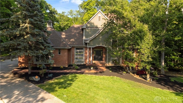 4384 New Market Banta Rd, Lewisburg, OH 45338 - view of front facade with a front yard, brick siding, and a shingled roof