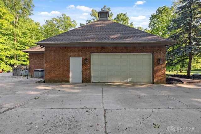 4384 New Market Banta Rd, Lewisburg, OH 45338 - view of side of home with brick siding, central air condition unit, concrete driveway, and roof with shingles