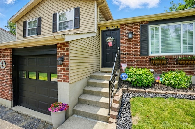 9675 Pellston Way, Miamisburg, OH 45342 - view of exterior entry with brick siding and a garage