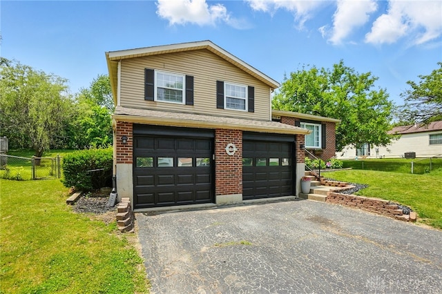 9675 Pellston Way, Miamisburg, OH 45342 - view of front of house featuring brick siding, asphalt driveway, a shingled roof, and an attached garage