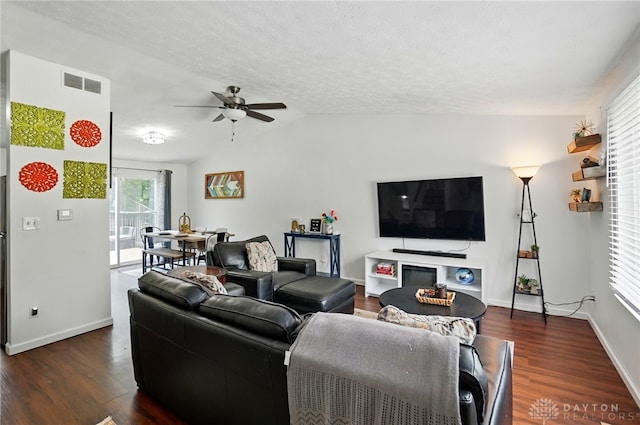 9675 Pellston Way, Miamisburg, OH 45342 - living area featuring ceiling fan, dark wood-style floors, lofted ceiling, baseboards, and a textured ceiling