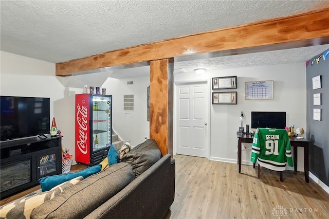 9675 Pellston Way, Miamisburg, OH 45342 - living room featuring beam ceiling, a textured ceiling, wood finished floors, and baseboards