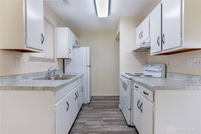 2648 Parklawn Dr, Kettering, OH 45440 - kitchen with white appliances, under cabinet range hood, a sink, light countertops, and white cabinetry
