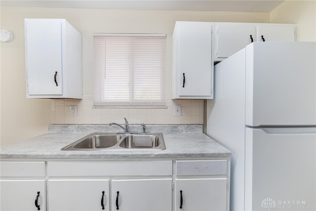 2648 Parklawn Dr, Kettering, OH 45440 - kitchen featuring freestanding refrigerator, a sink, light countertops, and white cabinets