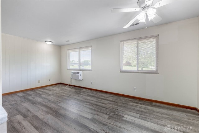 2648 Parklawn Dr, Kettering, OH 45440 - unfurnished room featuring a wall mounted AC, baseboards, wood finished floors, and ceiling fan