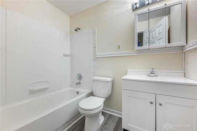 2648 Parklawn Dr, Kettering, OH 45440 - full bathroom featuring toilet, vanity, shower / bath combination, wood finished floors, and baseboards