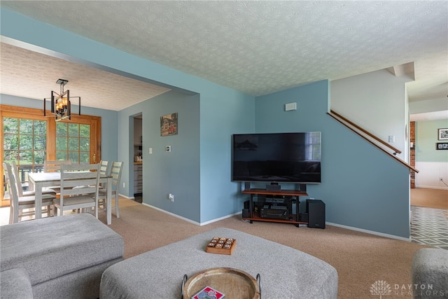 2547 Ryan Ct, Beavercreek, OH 45434 - carpeted living room featuring a chandelier, baseboards, and a textured ceiling