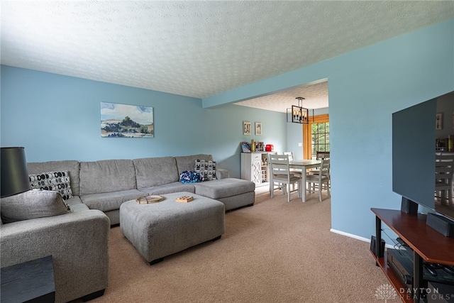 2547 Ryan Ct, Beavercreek, OH 45434 - living room with carpet flooring, a chandelier, a textured ceiling, and baseboards