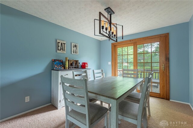 2547 Ryan Ct, Beavercreek, OH 45434 - dining area featuring light colored carpet, a chandelier, baseboards, and a textured ceiling