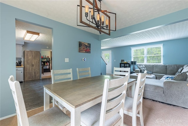 2547 Ryan Ct, Beavercreek, OH 45434 - carpeted dining room with a chandelier and a textured ceiling