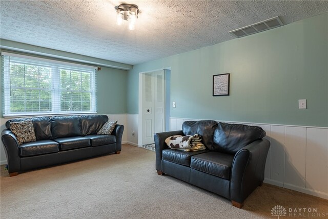 2547 Ryan Ct, Beavercreek, OH 45434 - living area with a textured ceiling, a wainscoted wall, and carpet flooring