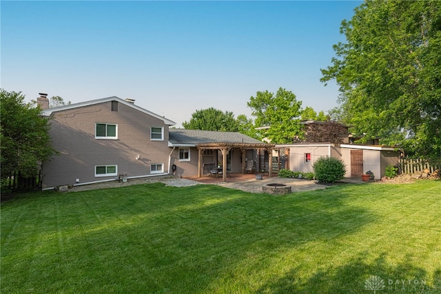 460 Rader Dr, Vandalia, OH 45377 - back of house featuring an outdoor fire pit, a patio area, a yard, and a chimney