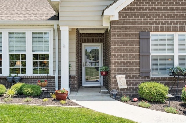 1215 Bourdeaux Way, Clearcreek Twp, OH 45458 - view of exterior entry with brick siding and a shingled roof