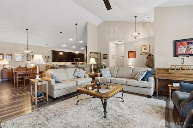 1215 Bourdeaux Way, Clearcreek Twp, OH 45458 - living area with wood finished floors, a chandelier, ceiling fan, and high vaulted ceiling