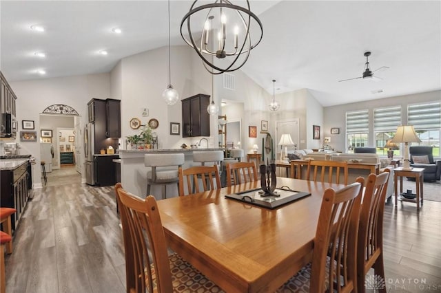 1215 Bourdeaux Way, Clearcreek Twp, OH 45458 - dining space with light wood-type flooring, a ceiling fan, a chandelier, and high vaulted ceiling