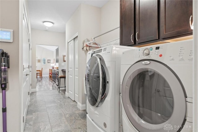 1215 Bourdeaux Way, Clearcreek Twp, OH 45458 - laundry room with cabinet space, independent washer and dryer, light marble finish floors, and baseboards