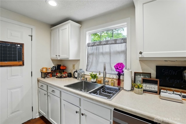 2755 S Blvd, Dayton, OH 45419 - kitchen featuring white cabinetry, light countertops, stainless steel dishwasher, recessed lighting, and a textured ceiling