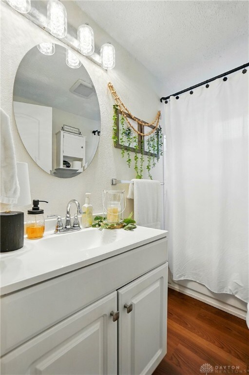 2755 S Blvd, Dayton, OH 45419 - full bath featuring vanity, wood finished floors, and a textured ceiling