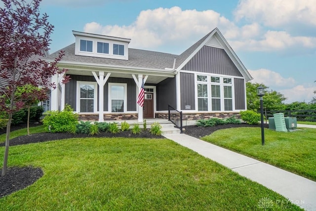 5053 Maiden Way, Liberty Twp, OH 45011 - view of front of house with a front yard, stone siding, roof with shingles, and covered porch