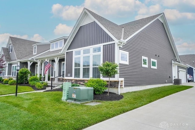 5053 Maiden Way, Liberty Twp, OH 45011 - view of property exterior with central air condition unit, a lawn, roof with shingles, and a garage