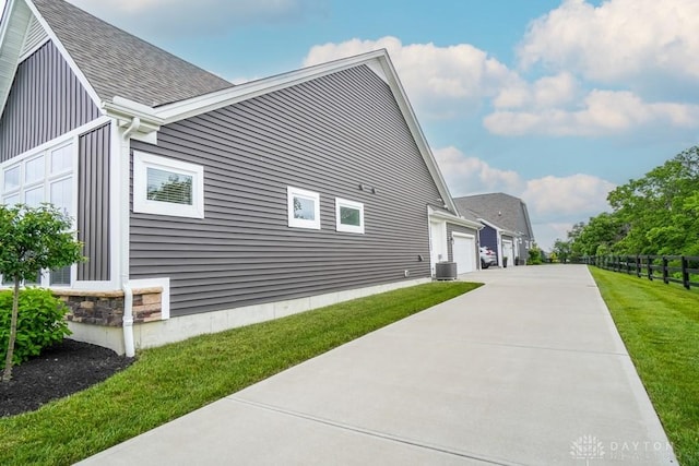 5053 Maiden Way, Liberty Twp, OH 45011 - view of side of home with cooling unit, roof with shingles, and concrete driveway