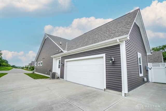 5053 Maiden Way, Liberty Twp, OH 45011 - view of side of property featuring central AC, roof with shingles, and concrete driveway