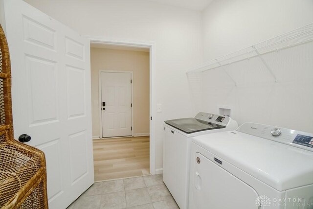 5053 Maiden Way, Liberty Twp, OH 45011 - laundry area with washing machine and dryer, baseboards, and light tile patterned floors