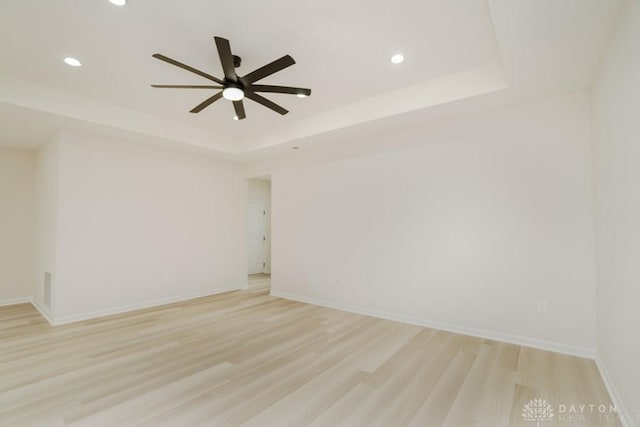 5053 Maiden Way, Liberty Twp, OH 45011 - spare room featuring a raised ceiling, recessed lighting, light wood-style floors, ceiling fan, and baseboards
