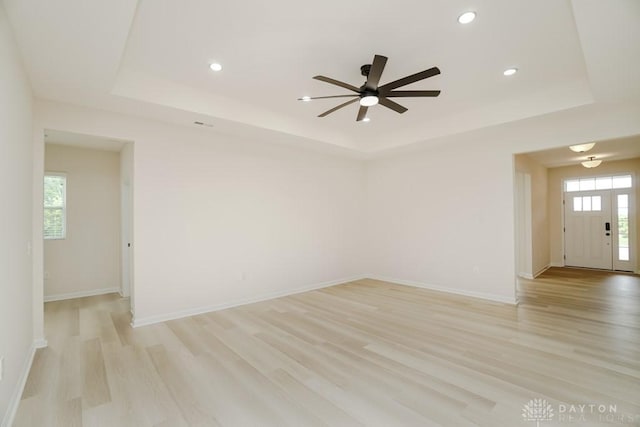 5053 Maiden Way, Liberty Twp, OH 45011 - empty room with a raised ceiling, light wood finished floors, a ceiling fan, plenty of natural light, and recessed lighting