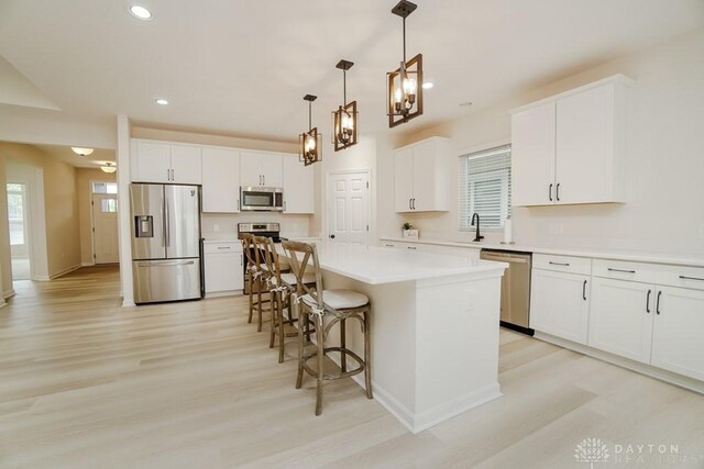 5053 Maiden Way, Liberty Twp, OH 45011 - kitchen with stainless steel appliances, light wood-style flooring, a sink, a center island, and recessed lighting