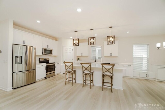 5053 Maiden Way, Liberty Twp, OH 45011 - kitchen with stainless steel appliances, light wood-type flooring, a center island, white cabinetry, and recessed lighting