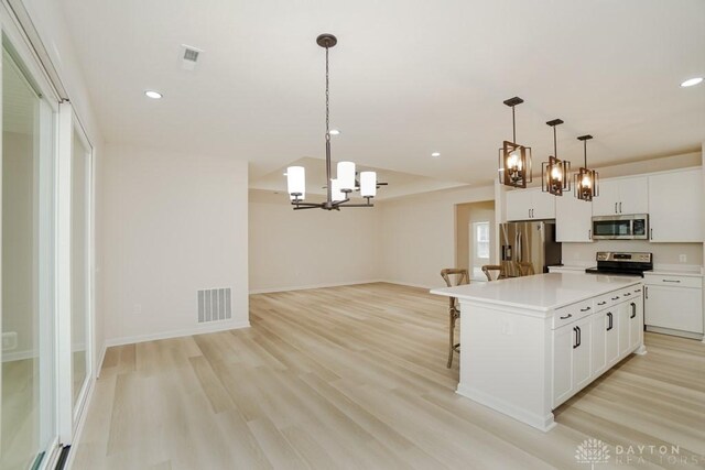 5053 Maiden Way, Liberty Twp, OH 45011 - kitchen with stainless steel appliances, a chandelier, light wood-style floors, open floor plan, and recessed lighting