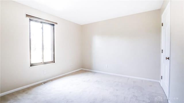 1918 Washington Dr S, Washington Twp, OH 45458 - spare room featuring light carpet, healthy amount of natural light, and baseboards
