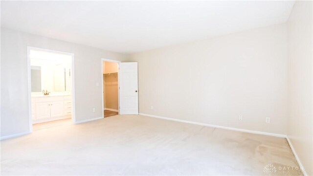 1918 Washington Dr S, Washington Twp, OH 45458 - unfurnished bedroom featuring a spacious closet, light carpet, baseboards, and a closet