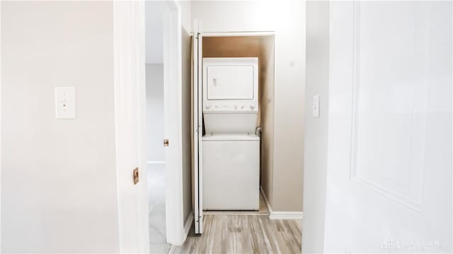 1918 Washington Dr S, Washington Twp, OH 45458 - washroom with estacked washer and dryer, light wood finished floors, and baseboards