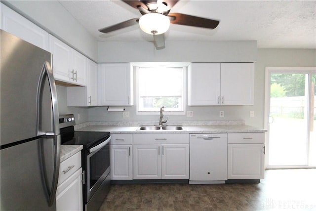 6959 Edenton Pleasant Plain Rd, Wayne Twp, OH 45162 - kitchen with stainless steel appliances, a sink, white cabinetry, and a ceiling fan