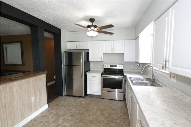 6959 Edenton Pleasant Plain Rd, Wayne Twp, OH 45162 - kitchen with appliances with stainless steel finishes, a sink, ceiling fan, white cabinets, and light countertops