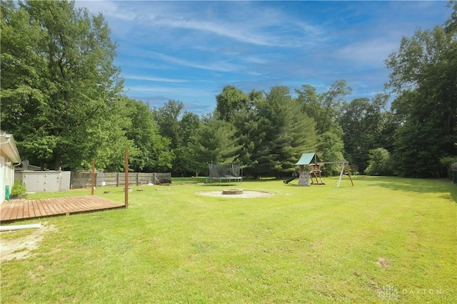 6959 Edenton Pleasant Plain Rd, Wayne Twp, OH 45162 - view of yard featuring a trampoline, a playground, and a deck