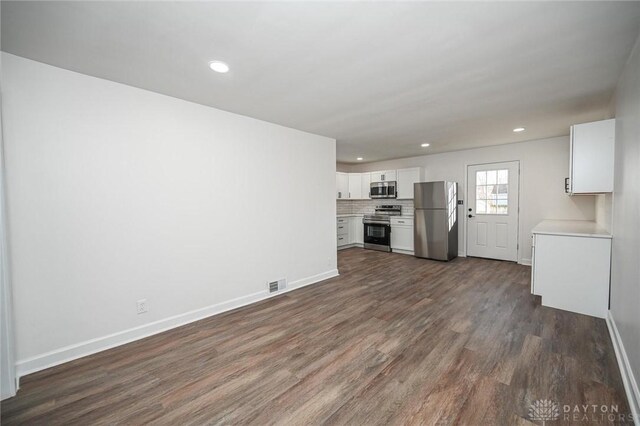 4612 Ward St, Cincinnati, OH 45227 - unfurnished living room featuring dark wood-style floors, baseboards, and recessed lighting