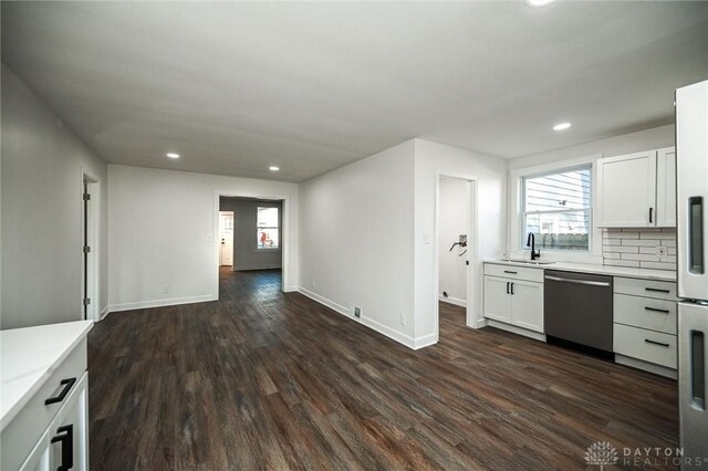 4612 Ward St, Cincinnati, OH 45227 - kitchen featuring stainless steel dishwasher, dark wood-style flooring, light countertops, recessed lighting, and a sink
