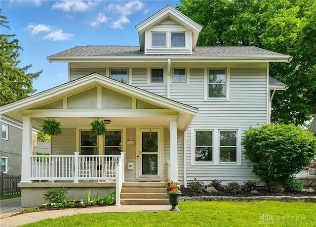 27 Spirea Dr, Oakwood, OH 45419 - american foursquare style home featuring covered porch, roof with shingles, and a front lawn