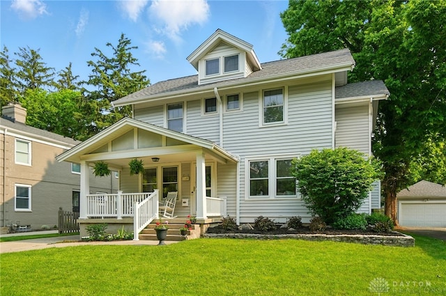 27 Spirea Dr, Oakwood, OH 45419 - american foursquare style home featuring a porch, a front lawn, a garage, and roof with shingles