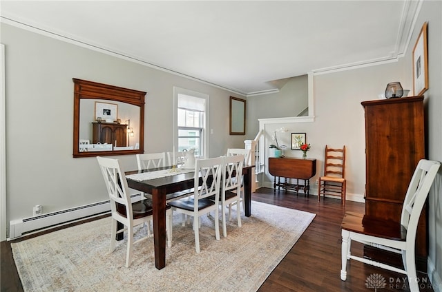 27 Spirea Dr, Oakwood, OH 45419 - dining area featuring dark wood-type flooring, crown molding, a baseboard heating unit, and stairway